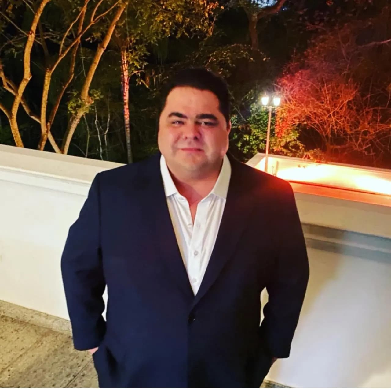 Mateus Gomes de paletó escuro em ambiente externo
